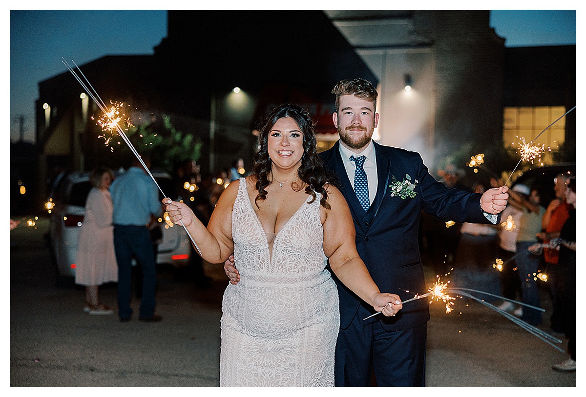 bride and groom doing a faux exit at their wedding with sparklers